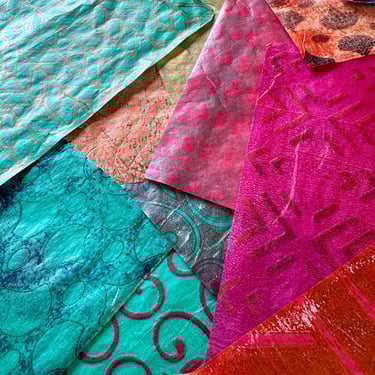 Colorful collage papers in teal, pink, and orange with layered patterns