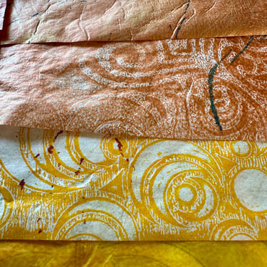 Hand-painted collage papers in gold and warm neutral tones with layered patterns