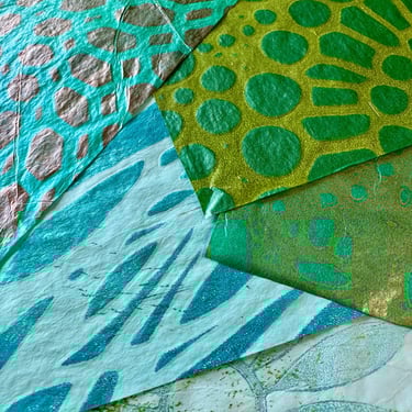 Green and turquoise collage papers with circular stencil pattern