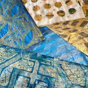 Blue and gold collage papers with circular stencil pattern