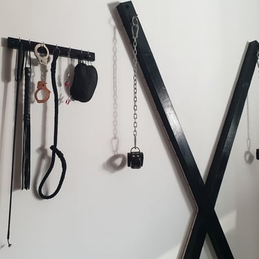St-Andrews-Cross-and-sex-toys-shelf-with-whips-blindfolds-leash-clamps-handcuffs