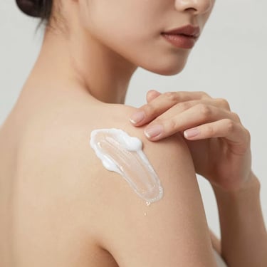 A smiling woman applying lotion on her hands in a bright, cozy room.