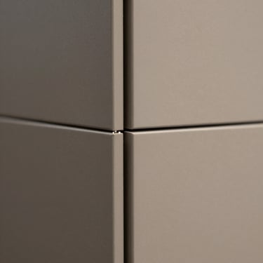 Extreme close-up of two rigid backdrop panels joined with a microscopic, flawless seam, demonstrating precise architectural scale.