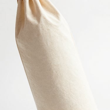 Bright high-key product photo of a canvas wine bottle bag, soft natural daylight, 50mm