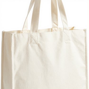 Bright high-key product photo of a boutique shopping bag, soft natural daylight, 50mm