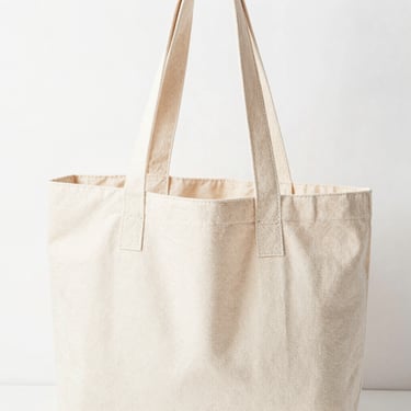 Bright high-key product photography of a heavy canvas tote bag with reinforced handles, clean white background, soft natural daylight, 50mm