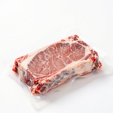 Macro shot of fresh raw beef tenderloin in vacuum seal, bright high-key studio lighting, sterile white background