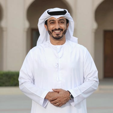Portrait of a confident young professional smiling against a sleek dark background.