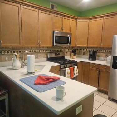a kitchen with a table and a refrigerator