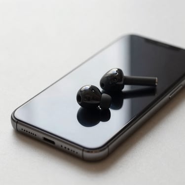 Close-up of a smartphone and wireless earbuds laid flat on a soft light surface, natural studio lighting, product centred with clean background