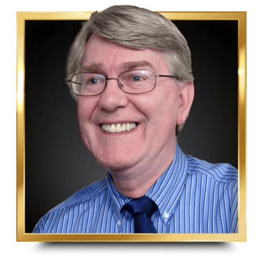 Dr. Glenn P. Wood in a blue shirt and tie