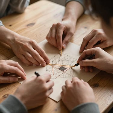 Hands collaborating on a structured art project on a wooden table, warm sunlight casting soft shadows, focus on the collective action.