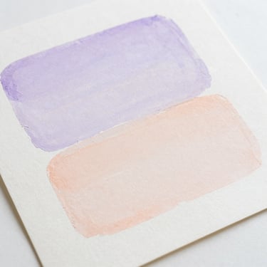 Flat-lay of a minimalist art print on textured cotton paper, soft lavender and peach pastel brushstrokes, diffused natural daylight, clean composition.
