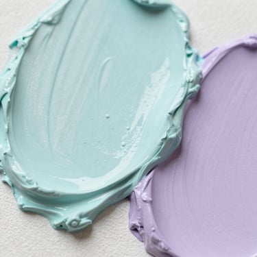 Macro shot of thick, textured oil paint on canvas, soft turquoise and lavender pigments, gentle shadows, 35mm lens editorial photography.
