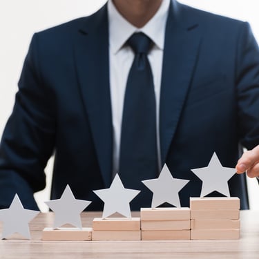 business professional setting up 5 stars on a platform 