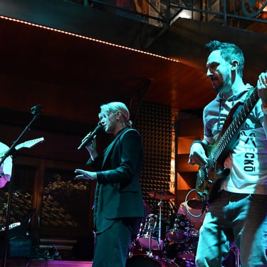 Jozef Bobula on bass with a female singer and a guitar player during a live concert