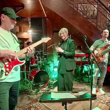 Jozef Bobula on bass with a female singer and a guitar player during a live concert