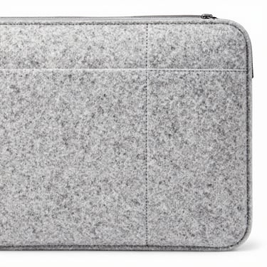 Close-up of clean stitching details on a premium grey felt laptop sleeve, macro focus, bright studio lighting