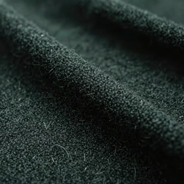 Macro texture shot of dark wool fabric, moody low-key lighting