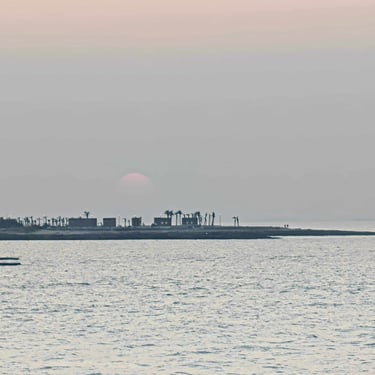 Gujarat trip details - A view of a coastal horizon at sunset, capturing the quiet stillness where the sea meets the sky.