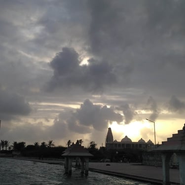 Gujarat trip details - A soulful silhouette of a coastal temple at sunset, capturing the quiet heritage of the shoreline.