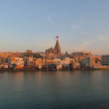 Dwarkadhish Temple Gujarat trip details - A soulful view of the Jagat Mandir at sunset along the Gomti River