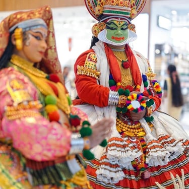 A close-up of vibrant Kathakali performers in traditional heritage costume, showcasing the soul of Kerala's culture