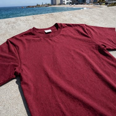 Close-up of a high-quality men's cotton t-shirt, streetwear style, flat-lay on concrete background