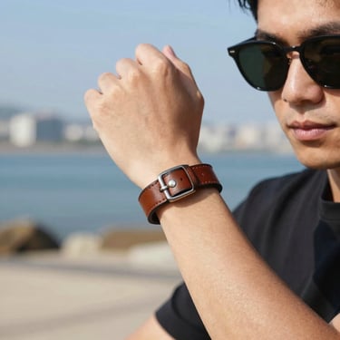 Men's casual leather bracelet and sunglasses, outdoor daylight