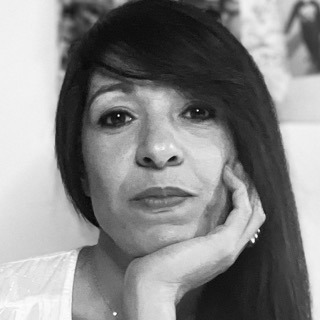 a woman with long hair and a white shirt