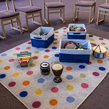 Musical instruments on spotty rug ready for toddler music group at Clavering Village Hall.