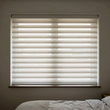 Interior of a modern bedroom with pale sage electric blinds providing soft, diffused lighting.