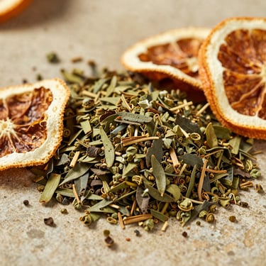 Close-up of premium yerba mate leaves blended with dried organic citrus peels on a warm stone surface