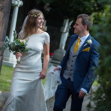 bride and groom walking around church grounds