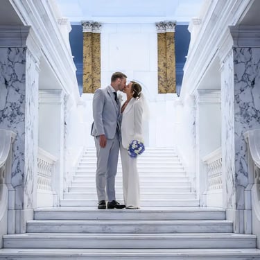 wedding couple standing on the steps inside Camden Town Hall