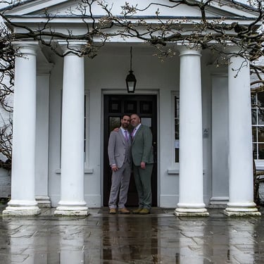 two grooms standing at the front door of Pembroke Lodge Richmond