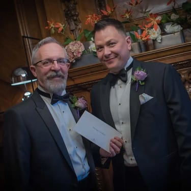 gay couple holding their certificate after their wedding at Old Marylebone Town Hall