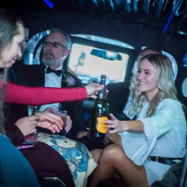 wedding party in the back of a limousine
