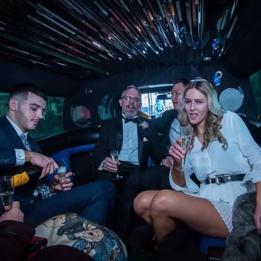 wedding party in the back of a limousine