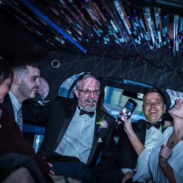 wedding party in the back of a limousine