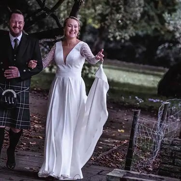 bride and groom taking a walk around the ground of Morden Park House