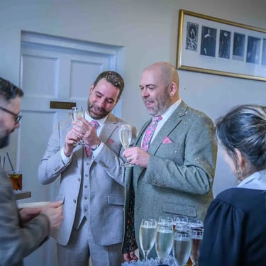 grooms having a first drink after their wedding ceremony