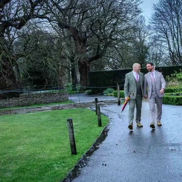 two grooms walking in the grounds of Pembroke Lodge