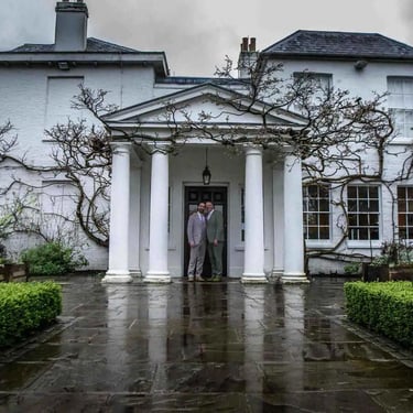 two grooms standing at the front door of Pembroke Lodge Richmond