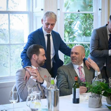 two grooms and a guest at their wedding