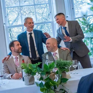 two grooms with guests at their wedding
