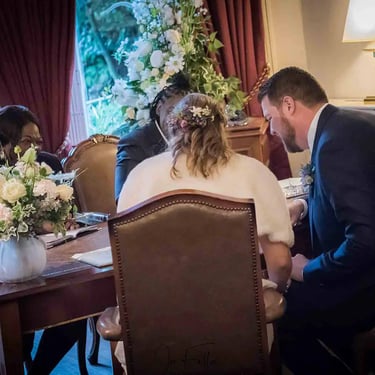 Newly weds signing the register in the Garden Room in Southwark Registry Office