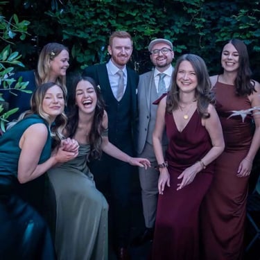 same-sex couple enjoying time with their wedding party before travelling to The Asylum Chapel Peckham