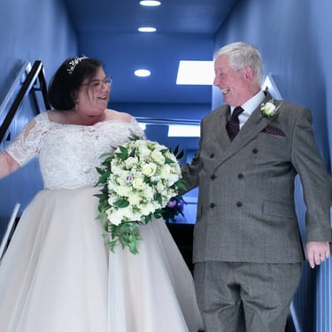 wedding couple walking down stairs