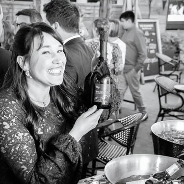 wedding guest holding a bottle of prosecco at the Rushmere Wimbledon